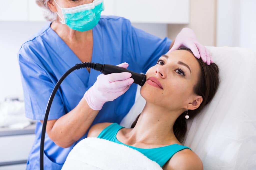 Woman receiving CoolSculpting treatment for fat reduction.